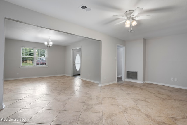 unfurnished living room featuring ceiling fan with notable chandelier and light tile patterned floors