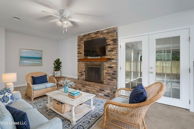 tiled living room with french doors, a fireplace, and ceiling fan