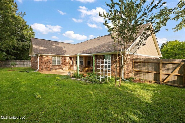 104 Willington Way, Madison, MS 39110 - rear view of property featuring brick siding, a patio area, and a fenced backyard