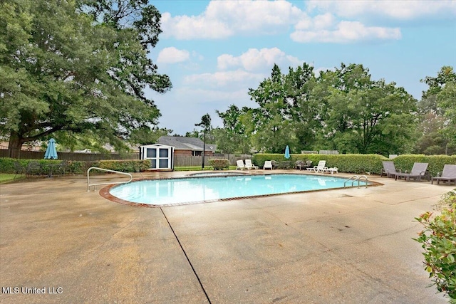 104 Willington Way, Madison, MS 39110 - community pool featuring a patio area, a storage unit, and view of wooded area