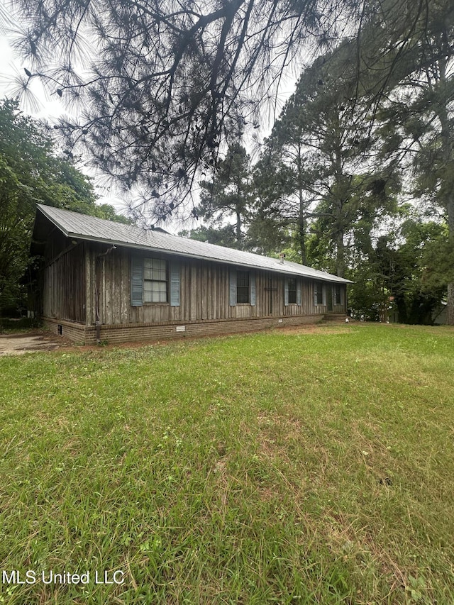 view of front of house with board and batten siding, a front yard, and crawl space