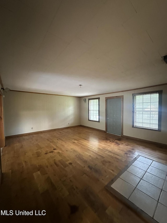 unfurnished room featuring wood finished floors and baseboards