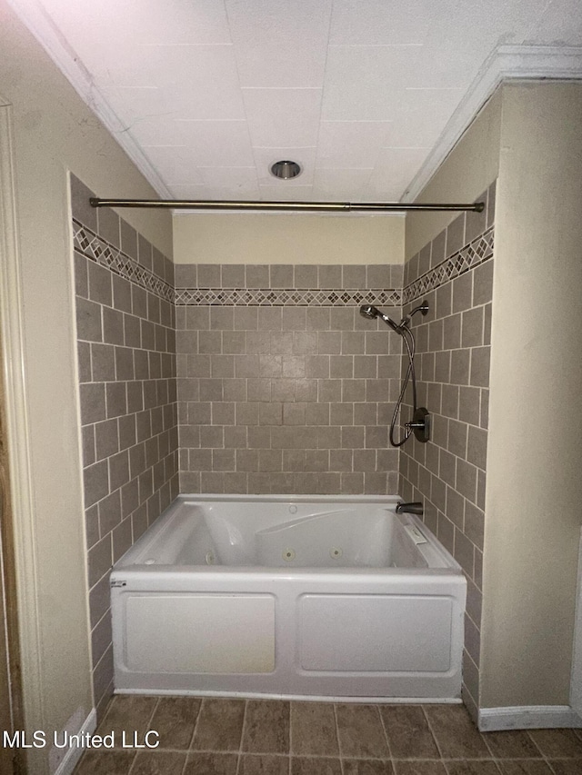 bathroom featuring a combined bath / shower with jetted tub, tile patterned floors, and baseboards