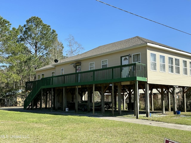 view of property featuring a carport and stairway