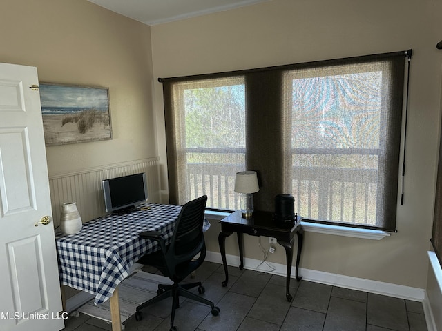 office space with tile patterned flooring and wainscoting