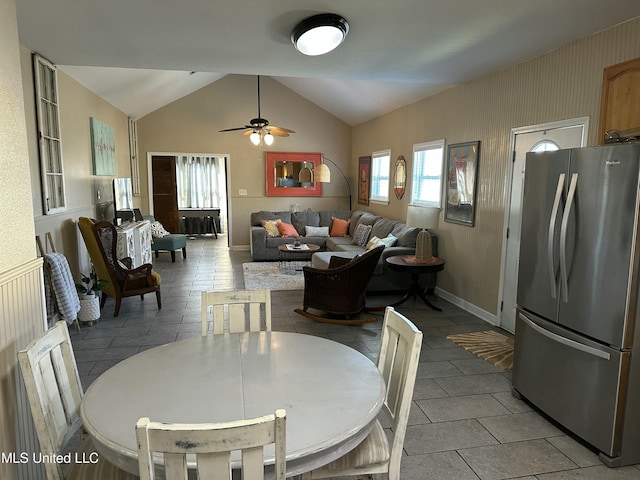 dining room featuring a ceiling fan and vaulted ceiling