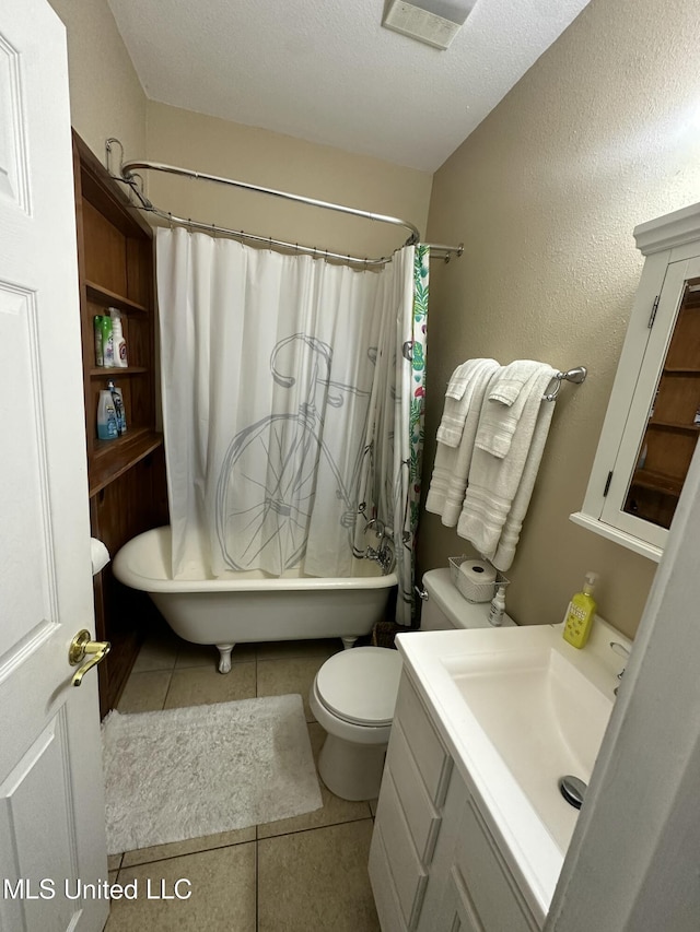 bathroom with tile patterned flooring, toilet, vanity, shower / tub combo, and a textured ceiling