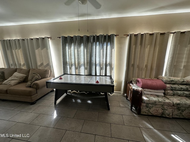 rec room featuring tile patterned floors and a ceiling fan