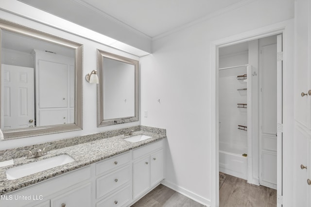 112 Rolling Meadows Dr, Jackson, MS 39211 - full bathroom with double vanity, wood finished floors, ornamental molding, shower / washtub combination, and baseboards