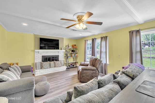 112 Rolling Meadows Dr, Jackson, MS 39211 - living room featuring plenty of natural light, a ceiling fan, wood finished floors, a fireplace, and crown molding