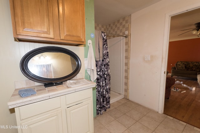 bathroom with ceiling fan, vanity, crown molding, curtained shower, and tile patterned flooring