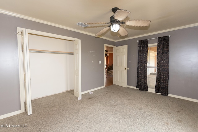 unfurnished bedroom featuring ornamental molding, carpet flooring, a closet, and ceiling fan