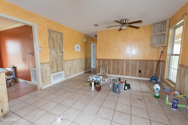 tiled spare room featuring ceiling fan