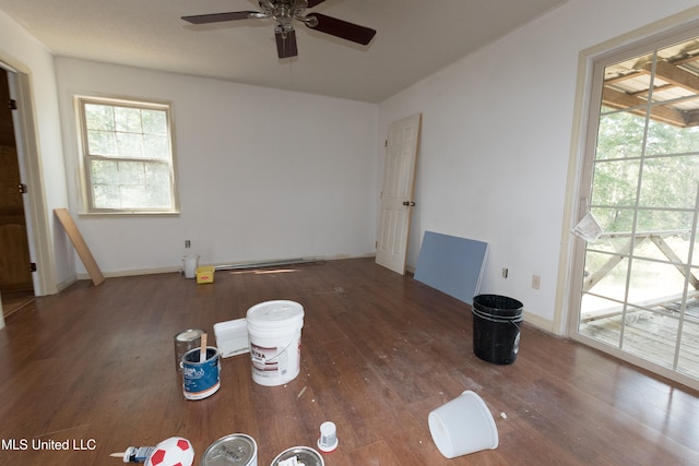 empty room with dark wood-type flooring and ceiling fan