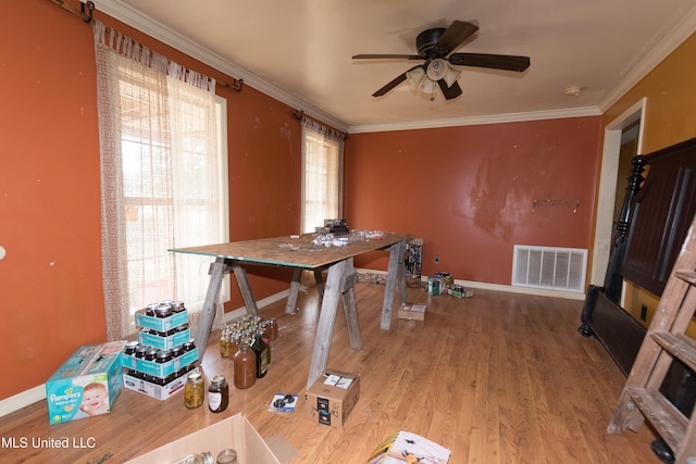 dining space with ceiling fan, wood-type flooring, and ornamental molding