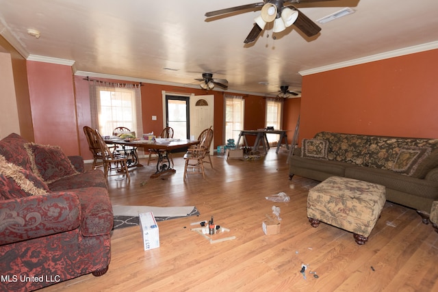 living room featuring light hardwood / wood-style floors, crown molding, and ceiling fan