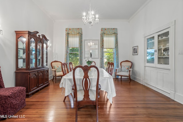 dining room featuring an inviting chandelier, crown molding, and dark hardwood / wood-style floors