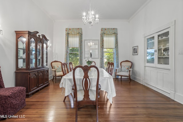 dining room featuring an inviting chandelier, baseboards, crown molding, and dark wood finished floors