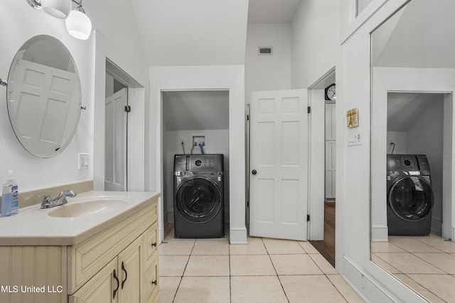 bathroom featuring tile patterned floors, washer / clothes dryer, and visible vents