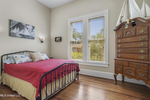 bedroom with baseboards and hardwood / wood-style floors