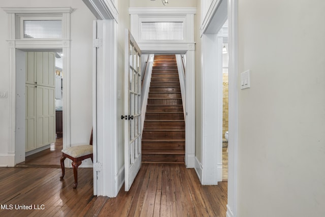hall with stairs, baseboards, and hardwood / wood-style flooring