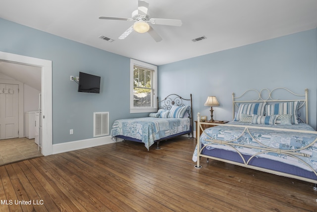 bedroom featuring washer / clothes dryer, visible vents, and hardwood / wood-style flooring