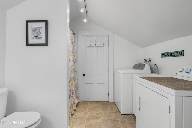 laundry room featuring washing machine and dryer and rail lighting