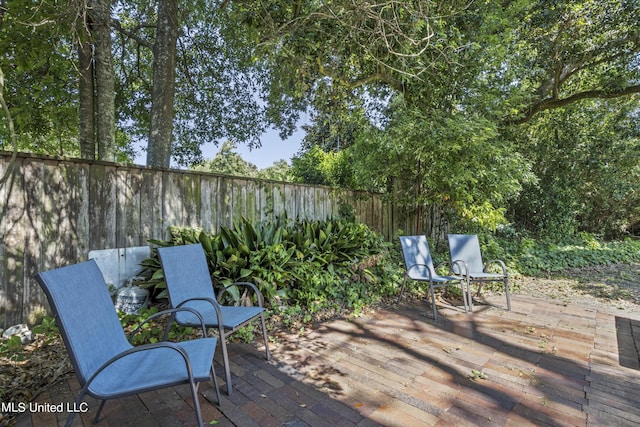deck featuring a fenced backyard and a patio area
