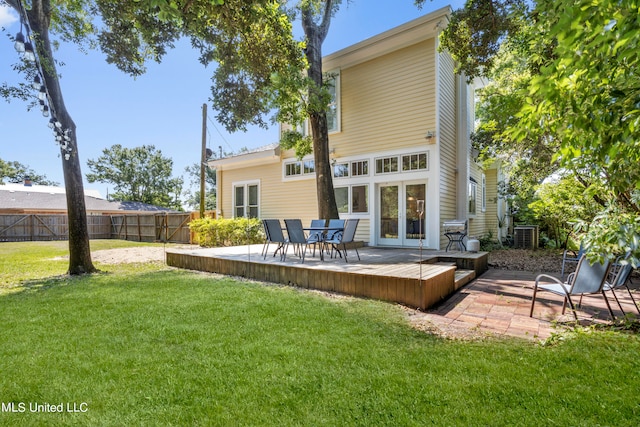 rear view of house featuring a yard and a wooden deck