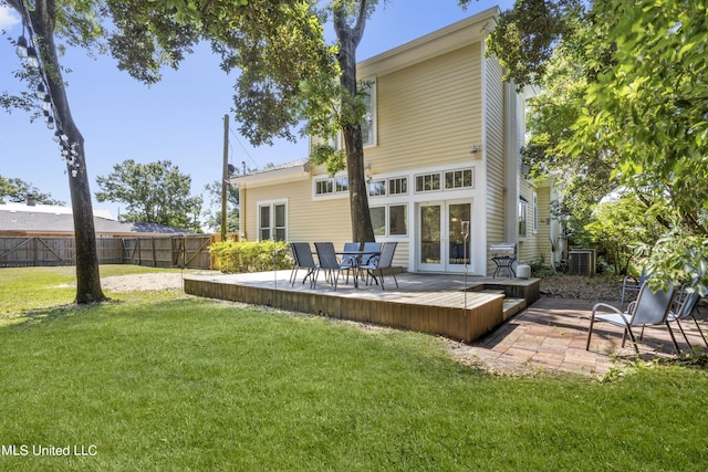 back of property featuring a lawn, fence, french doors, and a deck