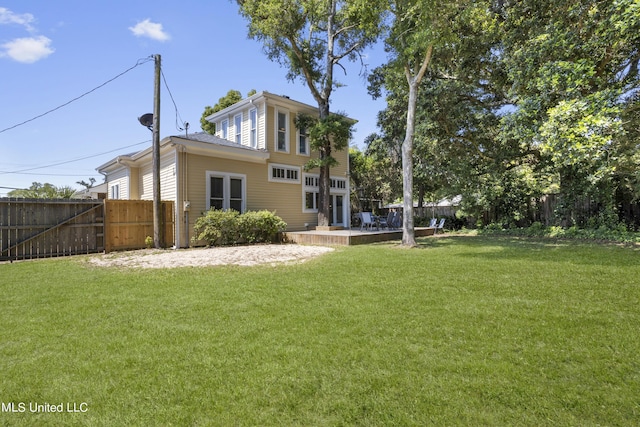 exterior space with a fenced backyard, a gate, a lawn, and a patio area