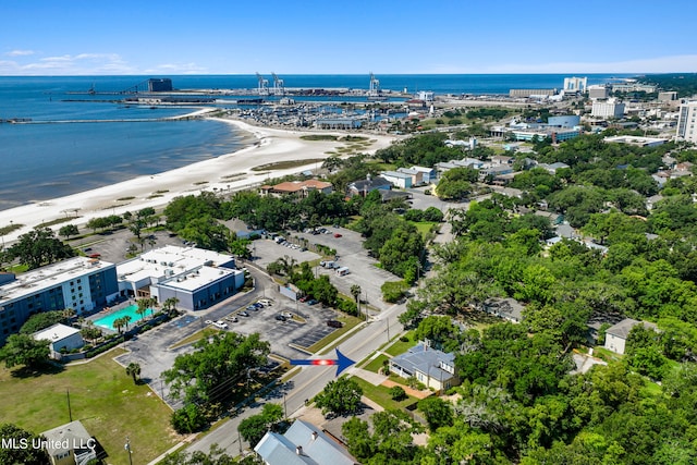 bird's eye view with a water view and a beach view