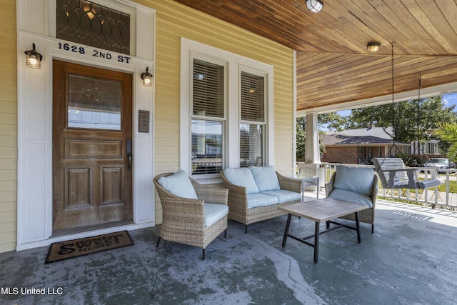 view of exterior entry featuring covered porch
