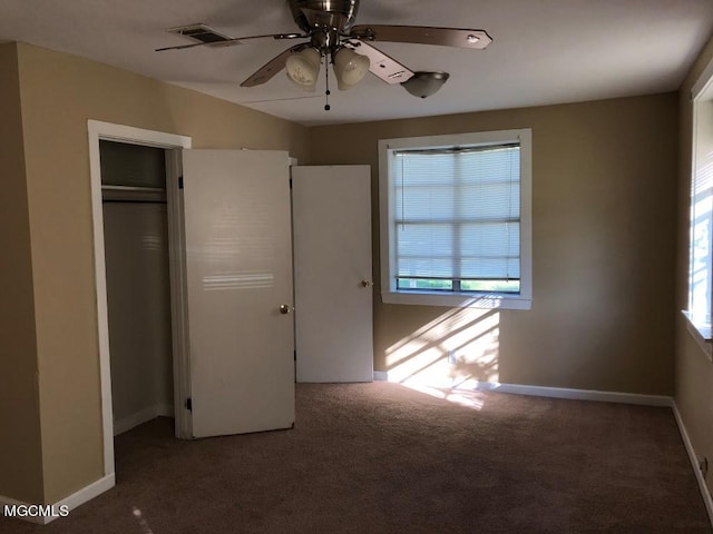 1412 Jo Ellen Cir, Gulfport, MS 39501 - unfurnished bedroom featuring carpet flooring, multiple windows, ceiling fan, and a closet