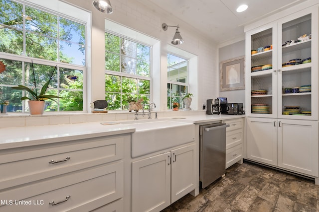 kitchen with dishwasher, ornamental molding, sink, white cabinets, and dark hardwood / wood-style flooring