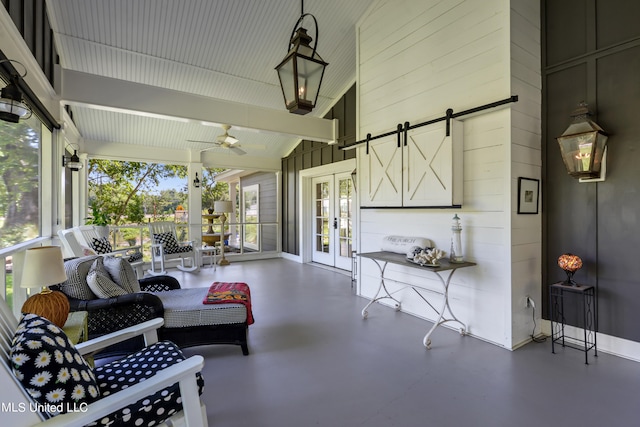 sunroom with vaulted ceiling with beams, french doors, a barn door, and ceiling fan