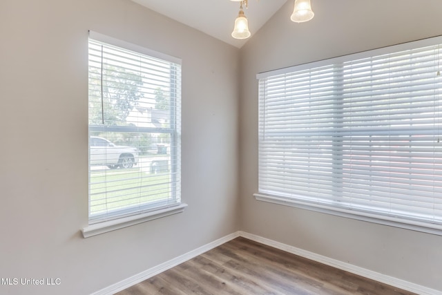 20 Oakmont Pl, Long Beach, MS 39560 - empty room featuring healthy amount of natural light, wood finished floors, and vaulted ceiling