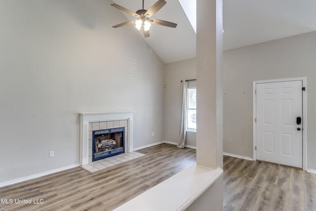 20 Oakmont Pl, Long Beach, MS 39560 - unfurnished living room featuring high vaulted ceiling, ceiling fan, wood finished floors, and a tiled fireplace