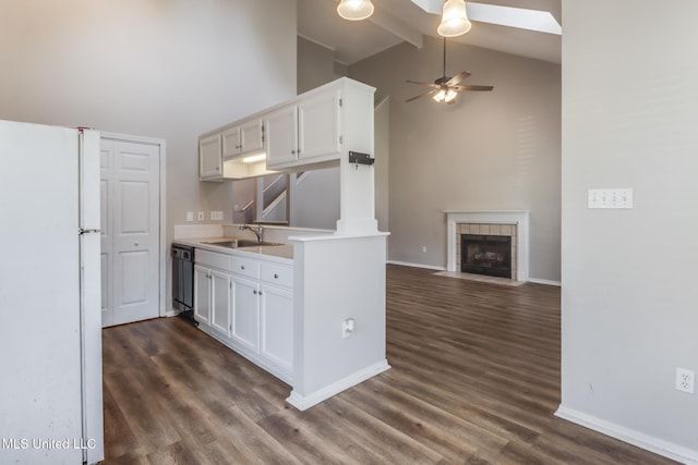 20 Oakmont Pl, Long Beach, MS 39560 - kitchen with freestanding refrigerator, high vaulted ceiling, a ceiling fan, a fireplace, and dark wood finished floors