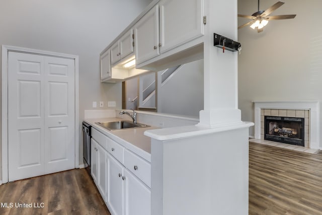 20 Oakmont Pl, Long Beach, MS 39560 - kitchen with dark wood-style flooring, light countertops, ceiling fan, a fireplace, and white cabinets