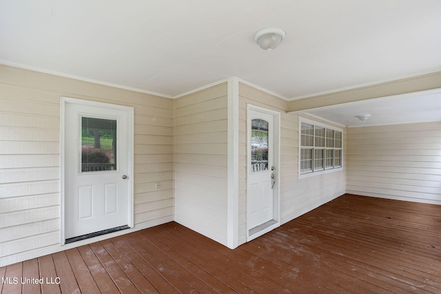 view of exterior entry with a wooden deck