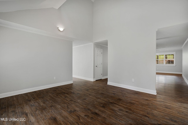 spare room with ornamental molding, dark hardwood / wood-style floors, and high vaulted ceiling