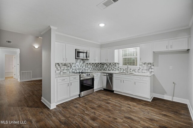 kitchen featuring appliances with stainless steel finishes, sink, dark hardwood / wood-style floors, and white cabinets