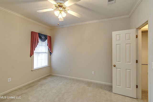 carpeted empty room featuring ceiling fan and ornamental molding