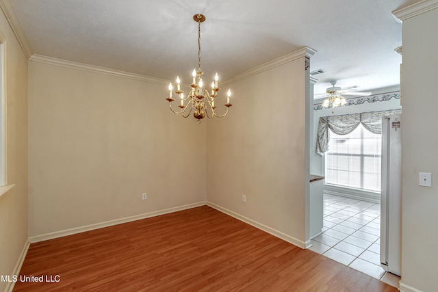 empty room featuring ceiling fan with notable chandelier, ornamental molding, and light wood-type flooring