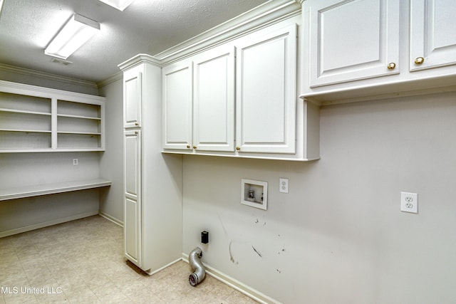 clothes washing area featuring hookup for a washing machine, crown molding, cabinets, and a textured ceiling