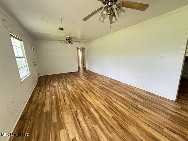 165 Canal St, Gulfport, MS 39507 - unfurnished room featuring a ceiling fan, wood finished floors, and baseboards