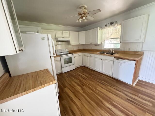 165 Canal St, Gulfport, MS 39507 - kitchen with white appliances, under cabinet range hood, a sink, crown molding, and dark wood-style flooring
