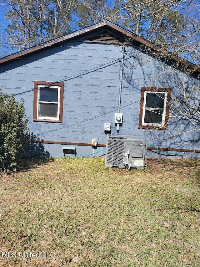 view of property exterior featuring cooling unit and a yard