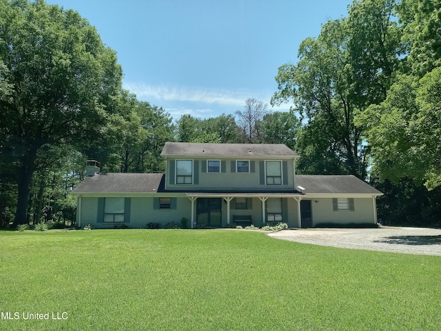 114 S 49th Hwy, Indianola, MS 38751 - view of front of property with a front yard, a chimney, gravel driveway, and view of wooded area